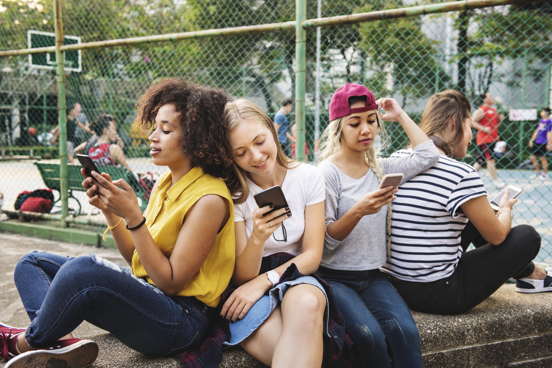 Friends discovering music together on their phones